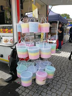 several buckets are stacked on top of each other in front of a food truck