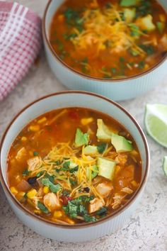 two bowls of chicken tortilla soup with avocado and cilantro