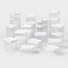 plastic containers with lids are stacked on top of each other in the shape of rectangles