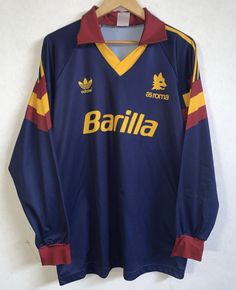 an old soccer jersey hanging on a hanger with the name barilia written on it