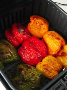 several peppers in a black container on a table