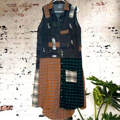 a patchwork shirt dress hanging on a wall