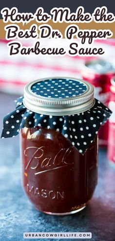 a mason jar filled with homemade bbq barbecue sauce on top of a blue counter