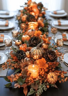 a long table is decorated with candles and pumpkins for thanksgiving dinner party decorating