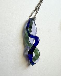 Green, blue, and purple braided glass pendant. I created this form by melting and braiding straight glass rods. Chain is optional. Handmade from borosilicate glass. Purple Braids, Jewelry Inspo, Glass Jewelry, Glass Pendant, Glass Pendants, Pendant Necklaces, Jewelry Necklace Pendant, Blue And Purple, Violet