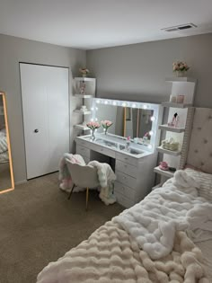 a bedroom with a bed, dresser and mirror on the wall next to each other