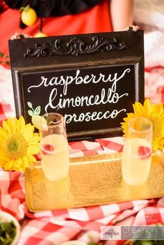 a sign that says raspberry lemoncells prosecco with two glasses on it