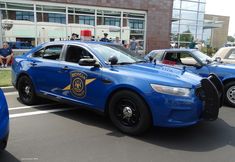 two police cars parked in front of a building