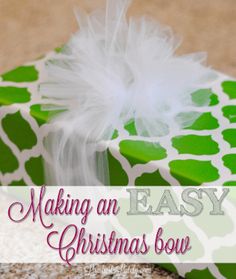 a green and white gift box with the words making an easy christmas bow on it