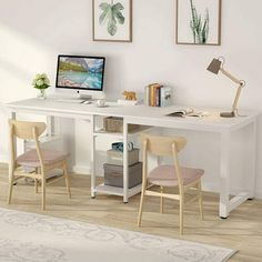 a white desk with two chairs and a computer on it