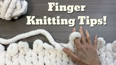 a hand is touching the end of a knitted blanket with text that reads finger knitting tips