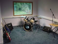 there is a drum set in the corner of this room