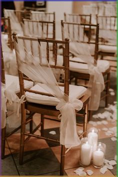 the chairs are decorated with ribbons and candles