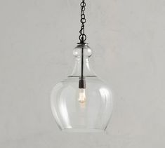 a clear glass light hanging from a chain