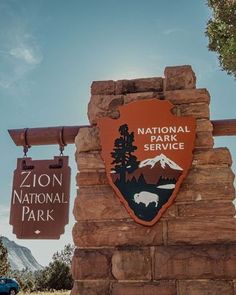 a sign for the national park service in front of a mountain