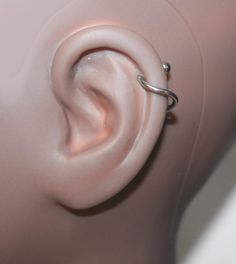 an ear is shown with a ring attached to it