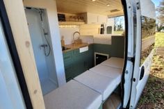 the interior of a camper van with its door open and no one in it