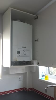 a kitchen with a sink, stove and cabinets in it's corner area next to a window