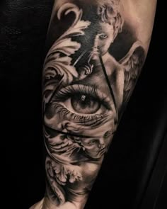 a tattoo with an all seeing eye on the arm and some other things around it