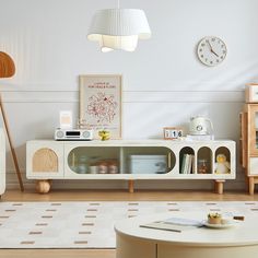 a living room filled with furniture and a clock on the wall