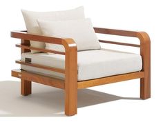 a wooden chair with two pillows on it's back and armrests, against a white background