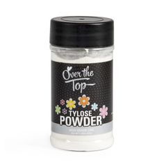 a jar of white powder with flowers on the top and black lid, in front of a