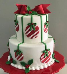 a three tiered christmas cake decorated with candy canes and bows