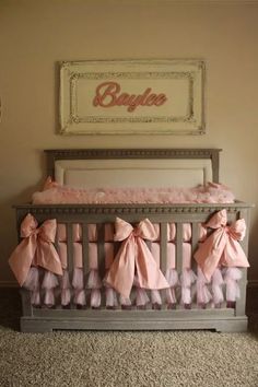 a baby crib with pink bows on it