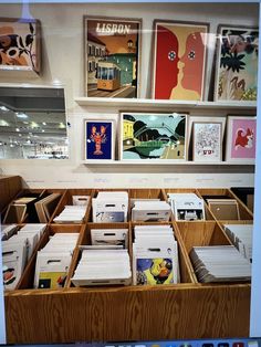 an open drawer filled with lots of mail in front of pictures on the wall behind it