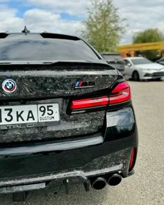 the back end of a bmw car parked in a parking lot