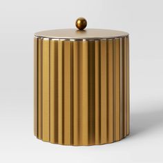 a golden container with a ball on top