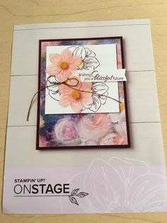 a close up of a card on a table with flowers in the background and an envelope that says stampin'up on stage