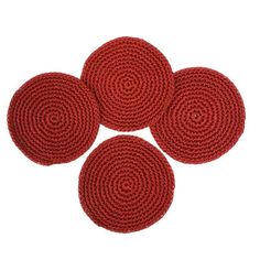 four red round rugs sitting on top of each other