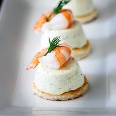 small appetizers with shrimp and cream cheese are on a white platter, ready to be eaten