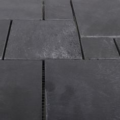 a close up view of a black tile floor