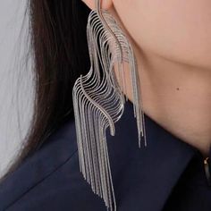 Introducing our Squiggly Line Silver Tassel Earrings – where art meets fashion for a bold and luxurious style statement! 🎨 **Artistic Innovation** 🎨These earrings are more than jewelry; they're wearable masterpieces. Crafted with hyper-realistic squiggly lines and bold contours, they mimic the look of cut and flexible edges, creating a unique work of art. ✨ **Silver Elegance** ✨Rhodium plated. They combine durability with a captivating shine. The silver tassel fringe adds movement, making them Metal Tassel Earrings For Party, Metal Tassel Drop Earrings For Party, Silver Fringe Metal Earrings, Silver Fringe Drop Earrings, Trendy Metal Tassel Earrings For Party, Long Drop Tassel Earrings For Party, Elegant Metal Tassel Earrings For Party, Elegant Fringe Metal Chandelier Earrings, Long Drop Metal Tassel Earrings For Party