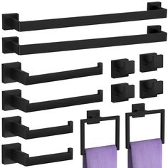 a set of black bathroom accessories including towels and toilet paper holders with purple towel on them