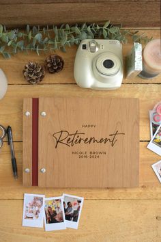 a wooden photo album sitting on top of a table filled with photos and other items