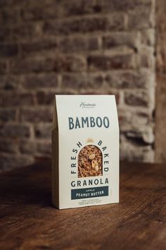 a bag of granola sitting on top of a wooden table next to a brick wall