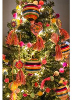 a brightly colored christmas tree decorated with ornaments