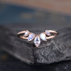 three pear shaped diamonds on top of a rock