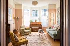 a living room filled with furniture and a piano