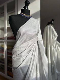 White and silver soft silk saree with an all over sheen. The perfect saree for parties and all traditional events. Versatile saree that can be styled with other blouses or same colour as saree. Message us for personalised bridesmaid saree quotes.   Blouse: unstitched, same fabric and colour as saree   #whitesaree #silversaree #whitesoftysilk   #silksareelook #softsilksaree #sareetrends #kuberapattu White And Silver Saree, Silver Colour Saree, Saree Quotes, Silver Saree, Bridesmaid Saree, White Saree, Indian Fashion Saree, Sarees Collection, Saree Trends