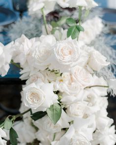 a bouquet of white flowers sitting on top of a table