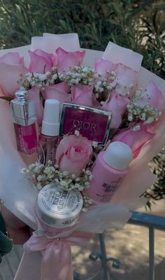 a bouquet of pink roses and beauty products