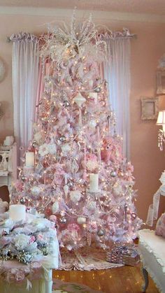 a pink christmas tree in a living room