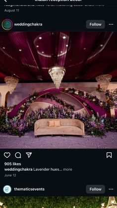 an image of a couch in the middle of a room with flowers and greenery