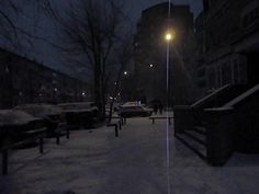 the street is covered in snow at night