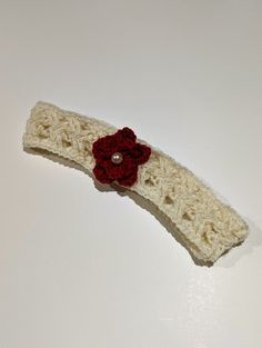 This hand knit baby headband was made with softness and comfort in mind. It is embellished with a small white pearl to add to the intricacy of the knitting pattern. Size: - Head size 17 inches (circumference) Fabric & Care: - 100% Merino Wool (Super-wash) - Use detergent for fine wash without softener Questions? - Feel free to reach out and we'll get back to you as soon as possible. Handmade Yarn Headband As Gift, Handmade One Size Headband For Gift, Handmade Headband Gift, Handmade Adjustable Cream Hair Accessories, Handmade Cream Headband, Handmade Cream Hair Headband, Handmade White Headband, Knit Baby Headband, Baby Red