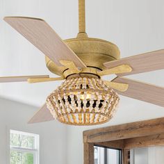 a chandelier hanging from a ceiling fan in a room